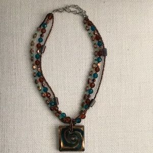 Multi beaded and strand necklace with pendant